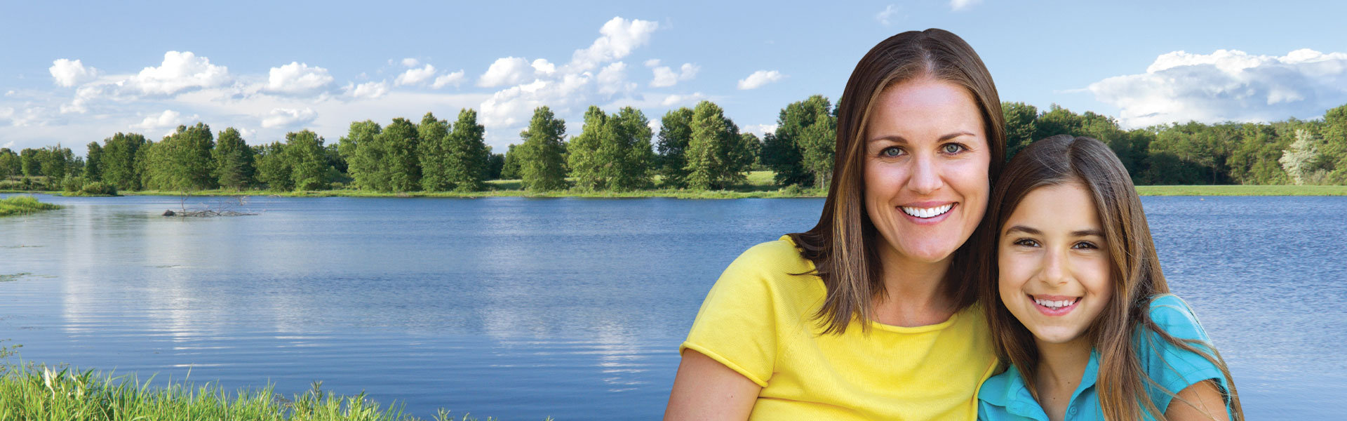 mother and daughter by lake